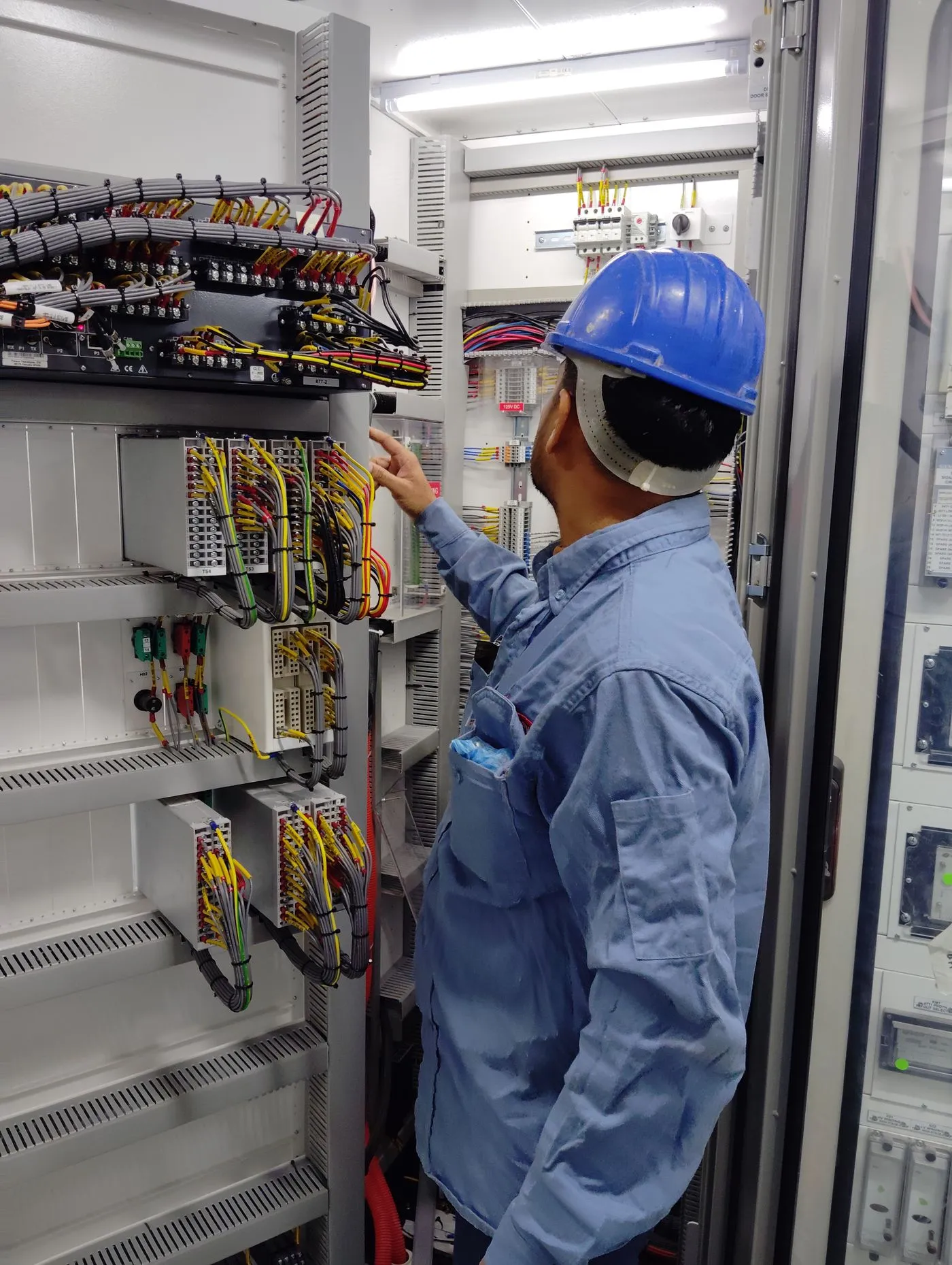 Sitewide supervisor at an electrical panel on site